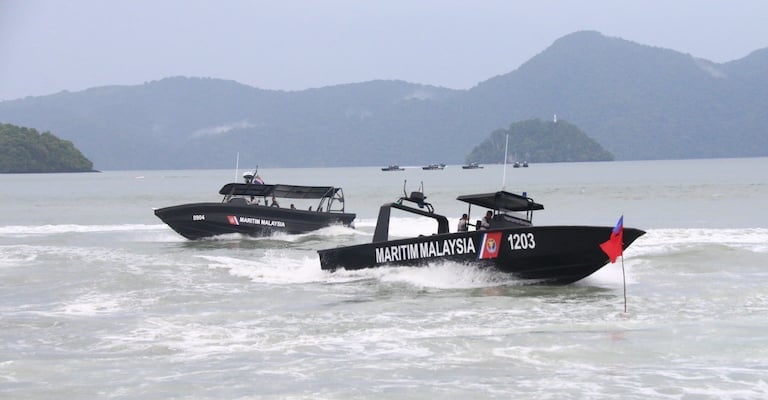 Malaysian Maritime Enforcement Agency patrol boats conducting operations related to unauthorised anchoring in Malaysia and maritime enforcement near key shipping routes